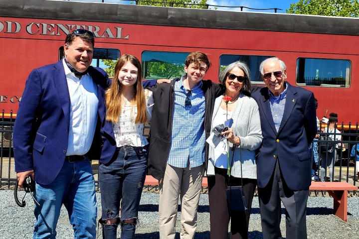a man standing in front of a group of people posing for the camera