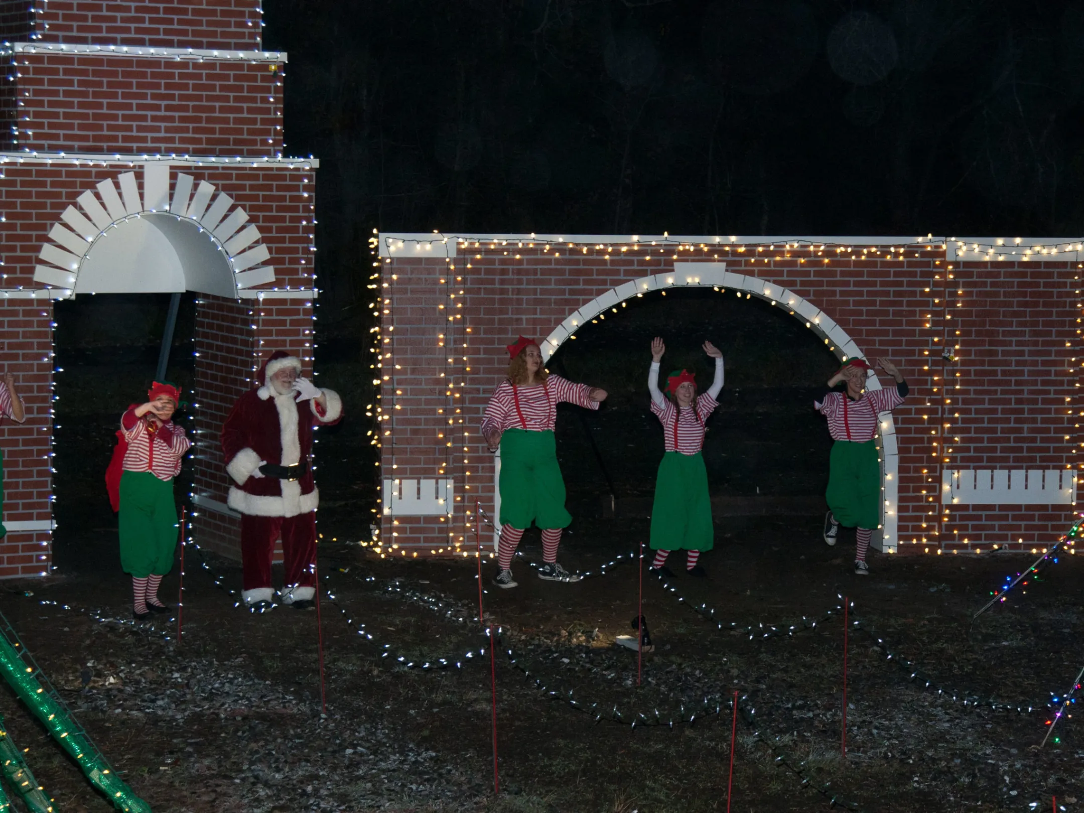 a group of people performing on stage in front of a building