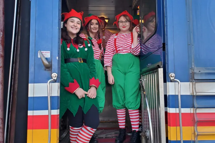 a group of people standing next to a train