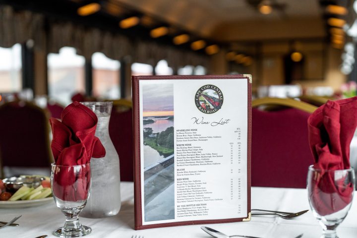 a person sitting at a table with a glass of wine