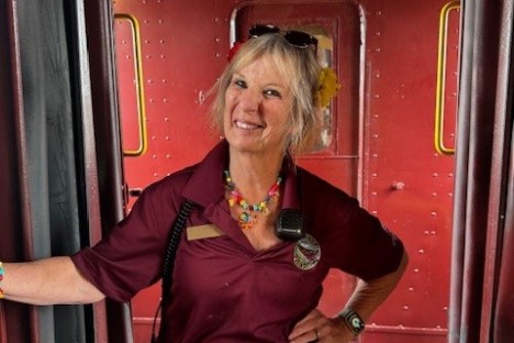 a woman standing in front of a bus